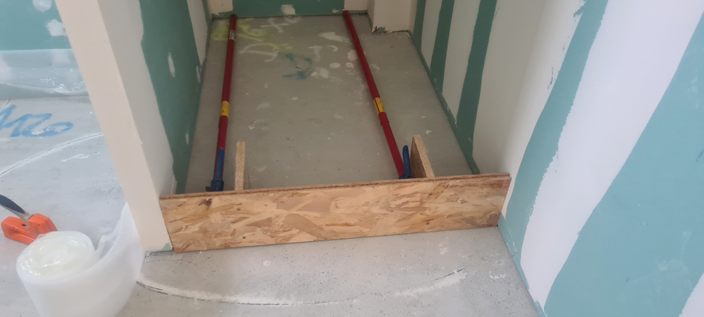 La barrière bricolée en OSB, pour séparer la douche du reste de la salle de bains